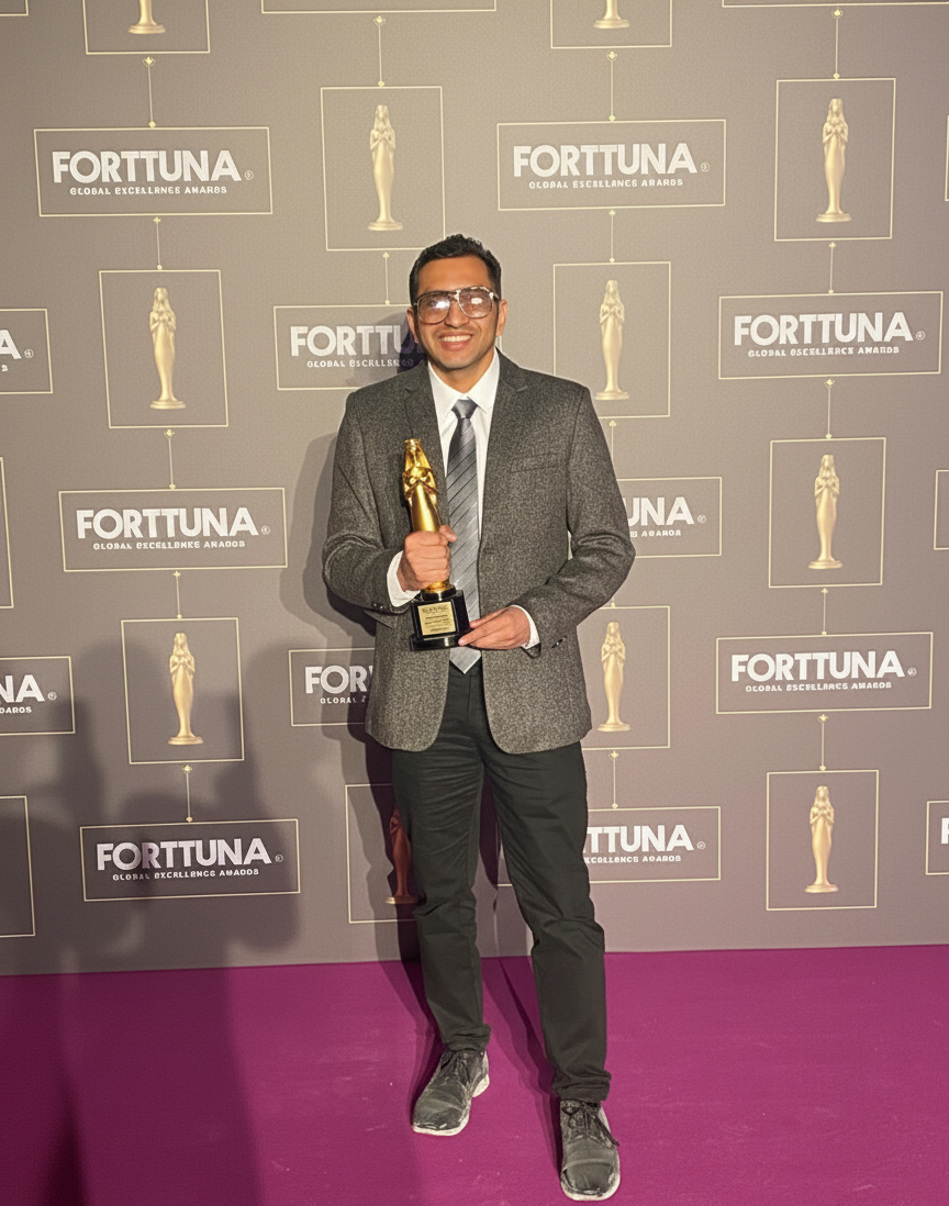 Pradeep Dahiya holding the award
